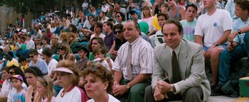 Movie still from “Free Willy” (1993), directed by Simon Wincer – A group of people sitting in a stadium watching a game; Medium shot, High angle