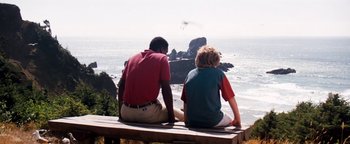 Movie still from “Free Willy” (1993), directed by Simon Wincer – Two people sitting on a bench looking out at the ocean; Wide shot, Over the shoulder angle