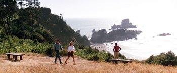 Movie still from “Free Willy” (1993), directed by Simon Wincer – A group of people walking on a hill near the ocean; Extreme Wide shot, High angle