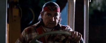 Movie still from “Free Willy” (1993), directed by Simon Wincer – An older man wearing a native american headdress; Close Up shot, Over the shoulder angle