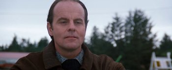 Movie still from “Free Willy” (1993), directed by Simon Wincer – A person wearing a jacket and tie; Close Up shot, Low angle