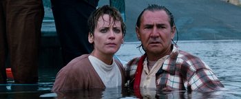 Movie still from “Free Willy” (1993), directed by Simon Wincer – A man and a woman standing in the water; Medium shot, High angle