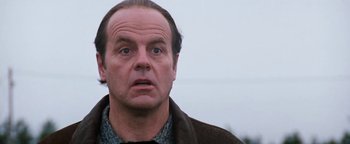 Movie still from “Free Willy” (1993), directed by Simon Wincer – A man with a beard and a jacket on looking at the camera; Close Up shot, Low angle