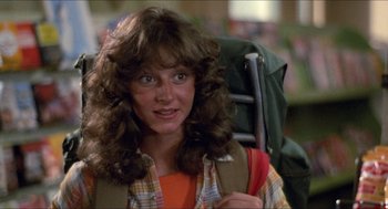 Movie still from “Friday the 13th” (1980), directed by Sean S. Cunningham – A woman with long brown hair is holding a backpack; Close Up shot, Low angle
