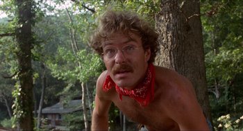 Movie still from “Friday the 13th” (1980), directed by Sean S. Cunningham – A shirtless man with a red bandanna around his neck; Close Up shot, Low angle