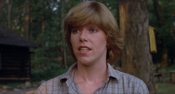 Movie still from “Friday the 13th” (1980), directed by Sean S. Cunningham – A young woman with long brown hair wearing a checkered shirt; Close Up shot, Low angle