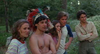 Movie still from “Friday the 13th” (1980), directed by Sean S. Cunningham – A group of people standing in a forest; Medium shot, Over the shoulder angle