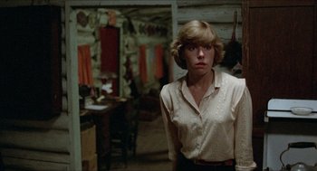 Movie still from “Friday the 13th” (1980), directed by Sean S. Cunningham – A woman standing in front of a table in a room; Medium shot, Over the shoulder angle