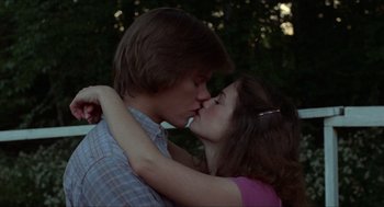 Movie still from “Friday the 13th” (1980), directed by Sean S. Cunningham – A man and a woman kissing each other in a forest; Close Up shot, Low angle