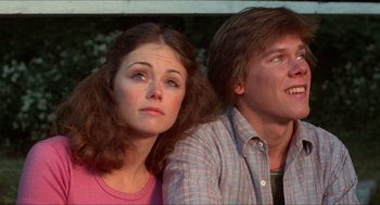 Movie still from “Friday the 13th” (1980), directed by Sean S. Cunningham – A man and a woman sitting next to each other in front of a window; Close Up shot, Low angle