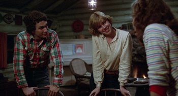 Movie still from “Friday the 13th” (1980), directed by Sean S. Cunningham – A woman standing in front of two other people; Medium shot, Over the shoulder angle