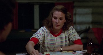Movie still from “Friday the 13th” (1980), directed by Sean S. Cunningham – A woman sitting at a table with papers in front of her; Medium shot, Over the shoulder angle