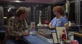 Movie still from “Friday the 13th” (1980), directed by Sean S. Cunningham – Two people sitting at a counter in a restaurant; Medium shot, Over the shoulder angle