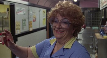 Movie still from “Friday the 13th” (1980), directed by Sean S. Cunningham – An older woman wearing glasses and a blue shirt; Close Up shot, Low angle