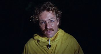 Movie still from “Friday the 13th” (1980), directed by Sean S. Cunningham – A man in a yellow raincoat with a mustache; Close Up shot, Low angle