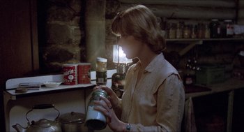 Movie still from “Friday the 13th” (1980), directed by Sean S. Cunningham – A woman holding a jar in a kitchen; Medium shot, Low angle