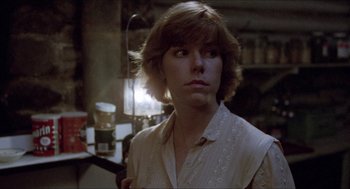 Movie still from “Friday the 13th” (1980), directed by Sean S. Cunningham – A woman in a white shirt is standing in a room; Close Up shot, Over the shoulder angle