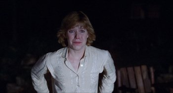 Movie still from “Friday the 13th” (1980), directed by Sean S. Cunningham – A woman in a white shirt is looking at the camera; Medium shot, Low angle