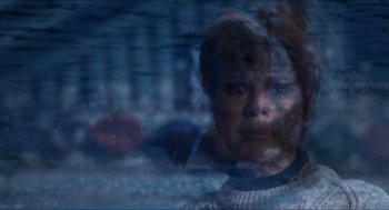 Movie still from “Friday the 13th” (1980), directed by Sean S. Cunningham – A woman is looking at the camera through a glass window; Close Up shot, Over the shoulder angle