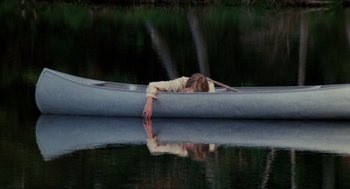 Movie still from “Friday the 13th” (1980), directed by Sean S. Cunningham – A woman laying on a boat in the water; Wide shot, High angle