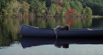 Movie still from “Friday the 13th” (1980), directed by Sean S. Cunningham – A woman laying in a canoe on the water; Wide shot, High angle