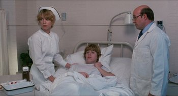 Movie still from “Friday the 13th” (1980), directed by Sean S. Cunningham – A woman in a hospital bed with two men; Medium shot, Over the shoulder angle