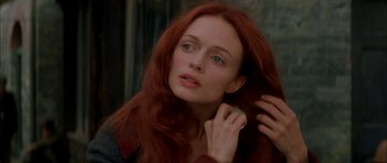 Movie still from “From Hell” (2001), directed by Allen Hughes – A woman with long red hair touching her hair; Close Up shot, Over the shoulder angle