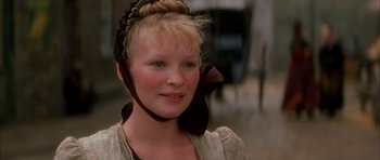 Movie still from “From Hell” (2001), directed by Allen Hughes – A young woman wearing a bow around her head; Close Up shot, Over the shoulder angle