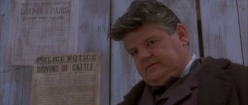 Movie still from “From Hell” (2001), directed by Allen Hughes – A person wearing a suit and tie; Close Up shot, Low angle