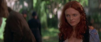Movie still from “From Hell” (2001), directed by Allen Hughes – A person with long red curly hair; Close Up shot, Over the shoulder angle