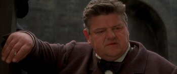 Movie still from “From Hell” (2001), directed by Allen Hughes – A person wearing a suit and tie; Close Up shot, Low angle