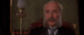 Movie still from “From Hell” (2001), directed by Allen Hughes – An old man with a beard and a long mustache; Close Up shot, Low angle