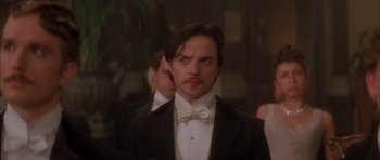 Movie still from “From Hell” (2001), directed by Allen Hughes – A man in a suit and bow tie; Close Up shot, Low angle