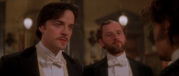 Movie still from “From Hell” (2001), directed by Allen Hughes – Two men in tuxedos are standing next to each other; Close Up shot, Low angle