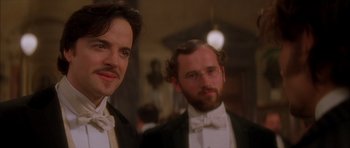 Movie still from “From Hell” (2001), directed by Allen Hughes – Two men in tuxedos standing next to each other; Close Up shot, Low angle