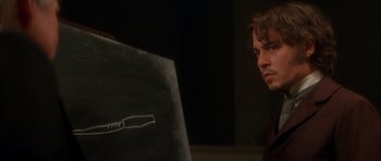 Movie still from “From Hell” (2001), directed by Allen Hughes – A man sitting in front of a computer screen; Close Up shot, Over the shoulder angle