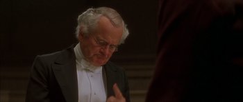 Movie still from “From Hell” (2001), directed by Allen Hughes – An older man in a tuxedo is looking down; Close Up shot, Low angle