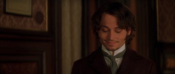 Movie still from “From Hell” (2001), directed by Allen Hughes – A person wearing a suit and tie; Close Up shot, High angle