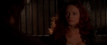 Movie still from “From Hell” (2001), directed by Allen Hughes – A woman with long red curly hair sitting in front of a window; Close Up shot, Over the shoulder angle