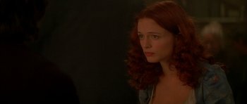 Movie still from “From Hell” (2001), directed by Allen Hughes – A beautiful young lady with red curly hair looking to her left; Close Up shot, Over the shoulder angle