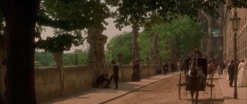 Movie still from “From Hell” (2001), directed by Allen Hughes – A group of people standing on the side of a road; Extreme Wide shot, High angle