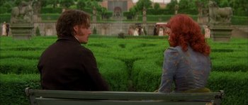 Movie still from “From Hell” (2001), directed by Allen Hughes – A man and a woman sitting on a bench in front of bushes; Medium shot, Over the shoulder angle
