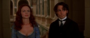 Movie still from “From Hell” (2001), directed by Allen Hughes – A man and a woman standing next to each other; Close Up shot, Low angle
