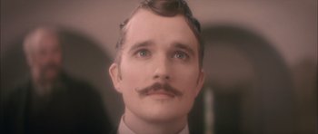 Movie still from “From Hell” (2001), directed by Allen Hughes – A person with a mustache; Close Up shot, Low angle