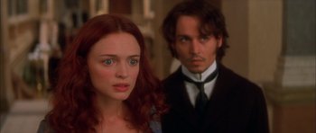 Movie still from “From Hell” (2001), directed by Allen Hughes – A man and a woman standing next to each other; Close Up shot, Over the shoulder angle