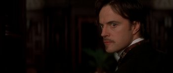 Movie still from “From Hell” (2001), directed by Allen Hughes – A person with a mustache; Close Up shot, Over the shoulder angle