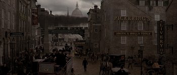 Movie still from “From Hell” (2001), directed by Allen Hughes – An image of people walking down the street in the dark; Extreme Wide shot, High angle