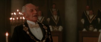 Movie still from “From Hell” (2001), directed by Allen Hughes – An old man wearing a suit and a bow tie; Close Up shot, Low angle