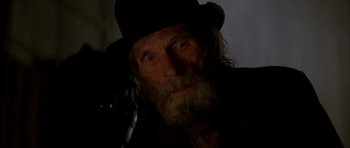 Movie still from “From Hell” (2001), directed by Allen Hughes – An old man with a long beard wearing a black hat; Close Up shot, Low angle