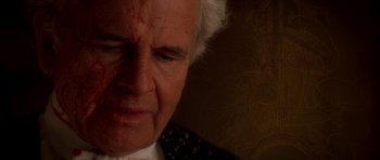 Movie still from “From Hell” (2001), directed by Allen Hughes – An older man with a blood covered face; Close Up shot, Over the shoulder angle